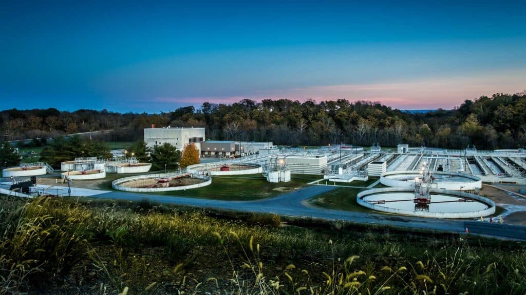 Overlooking the Frederick-Winchester Service Authority Green Energy Facility.|Large green pipes inside the facility and other controls/equipment.|Domed grey and white wastewater processing tanks|Exterior view of the Frederick-Winchester Service Authority Green Energy Facility||||