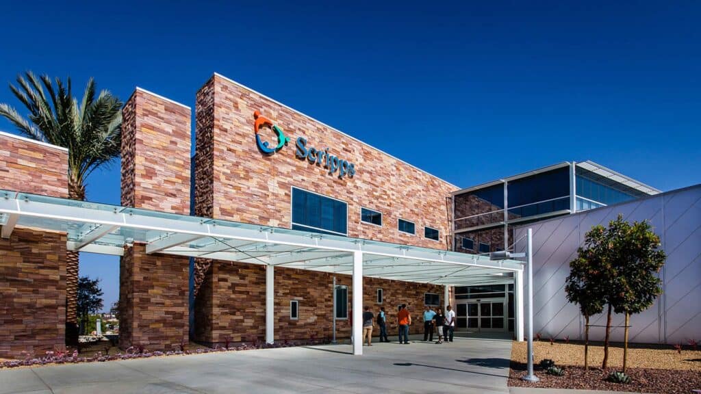 Exterior photo of entrance to California Proton Cancer Therapy Center|Haskell Footer background image|Blue background municipal project with tree inspired sculpture||