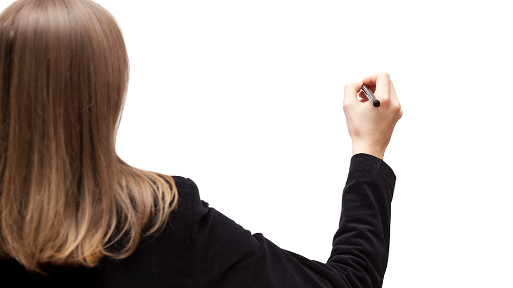 Woman writing on whiteboard.|Figure 1||