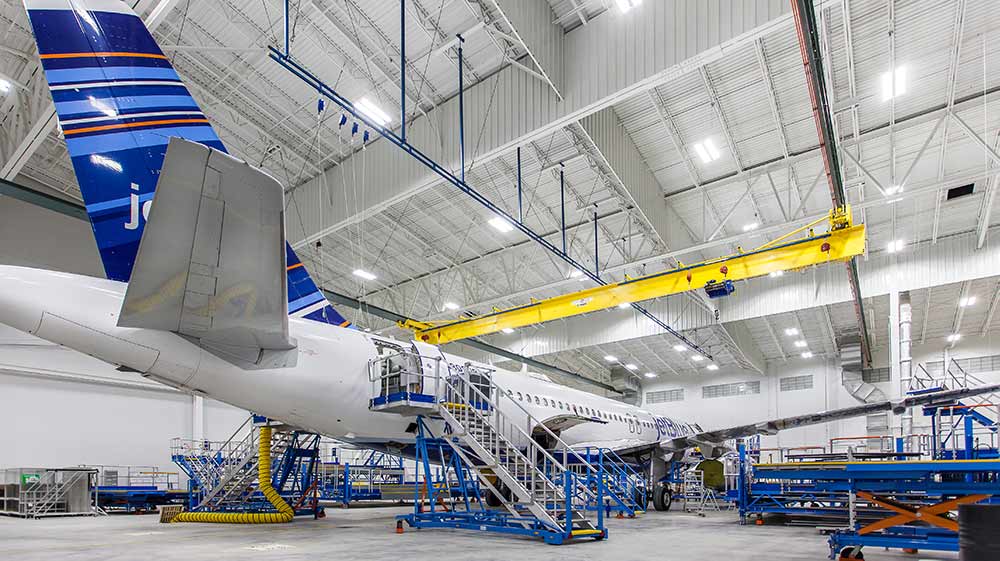 Airplane sitting inside Lufthansa Technik Heavy Maintenance Facility.|