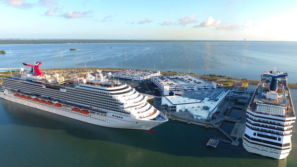 Aerial photo of the Canaveral Port Authority Cruise Terminal 5. Two cruise ships in port at the updated terminal.
