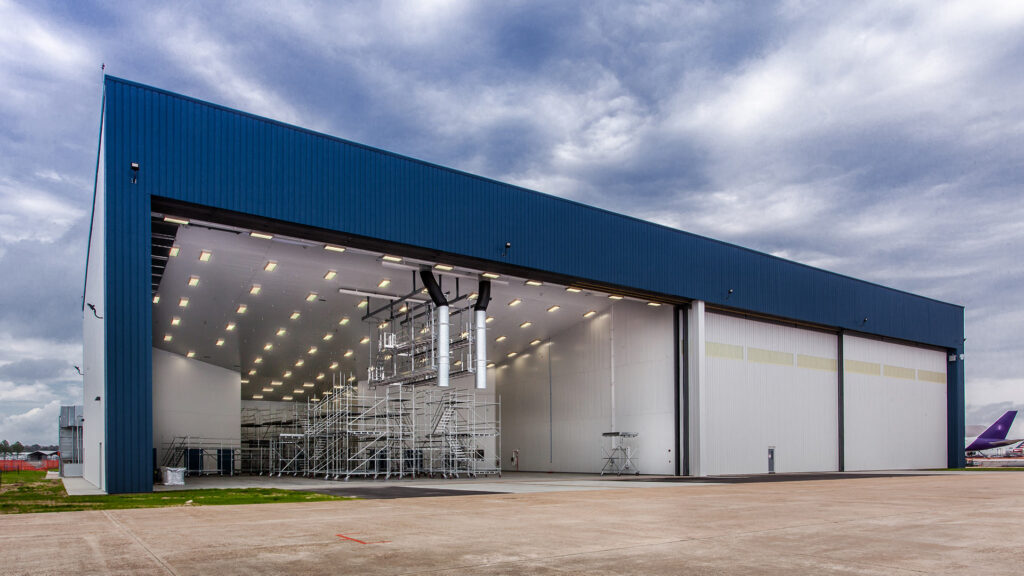 Exterior of MAAS Aviation Painting Facility. Hangar door open showing inside of painting facility.