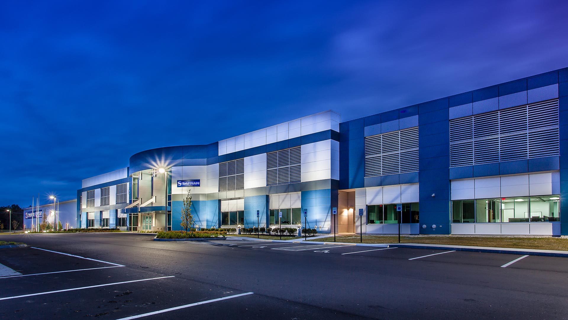 Front entrance of SAFRAN Aerospace Composite Facility in the evening.